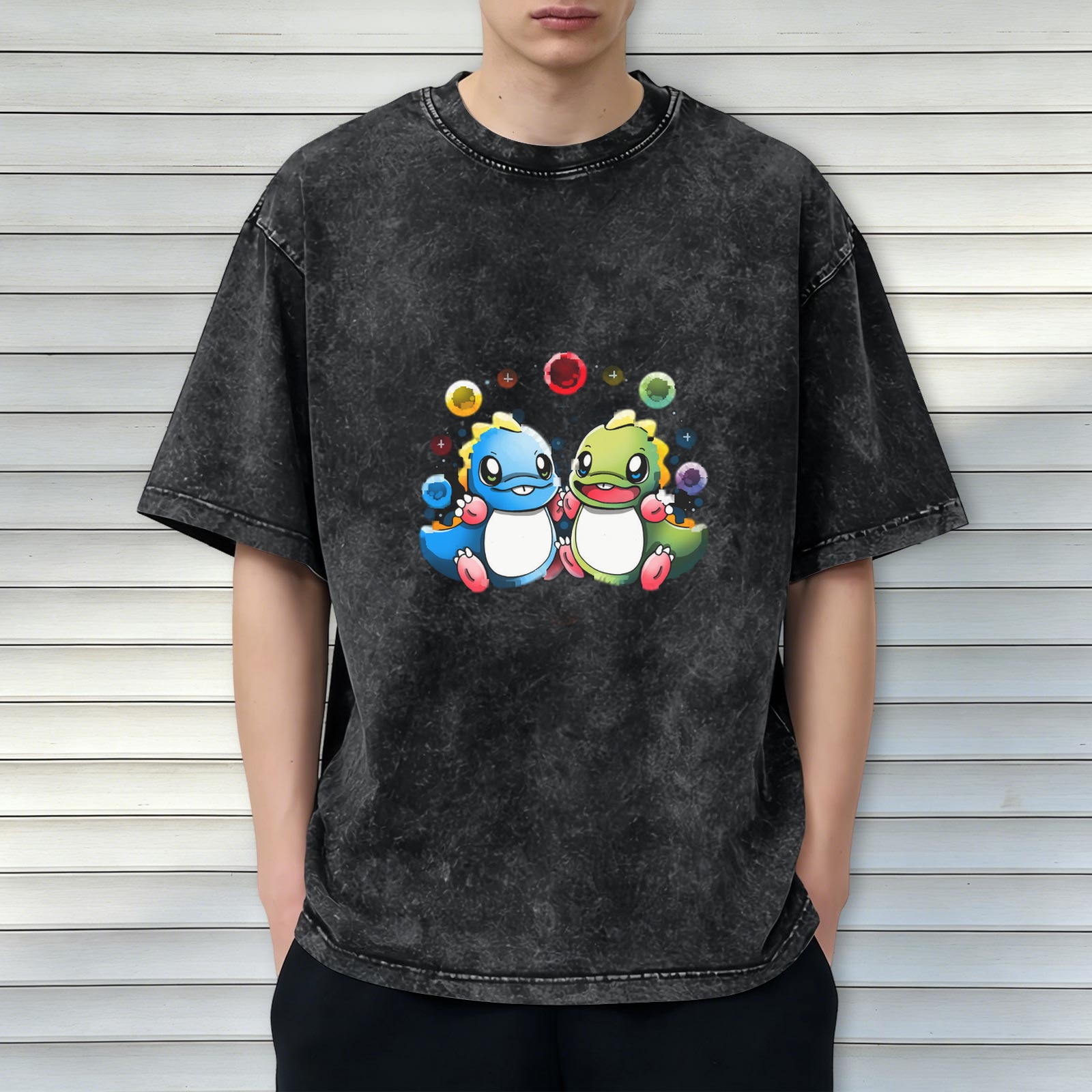 Washed black graphic t-shirt with cute cartoon dinosaurs and colorful bubbles