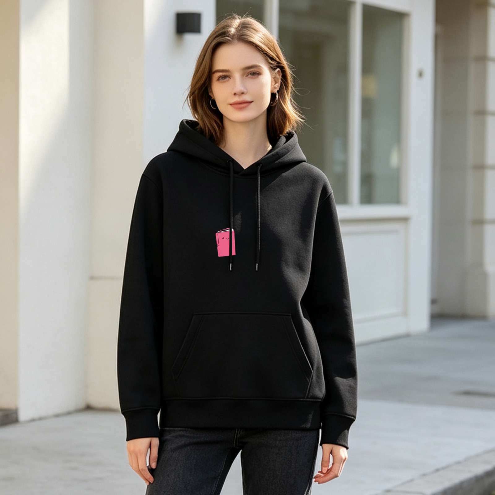 Black hoodie with small pink book graphic print