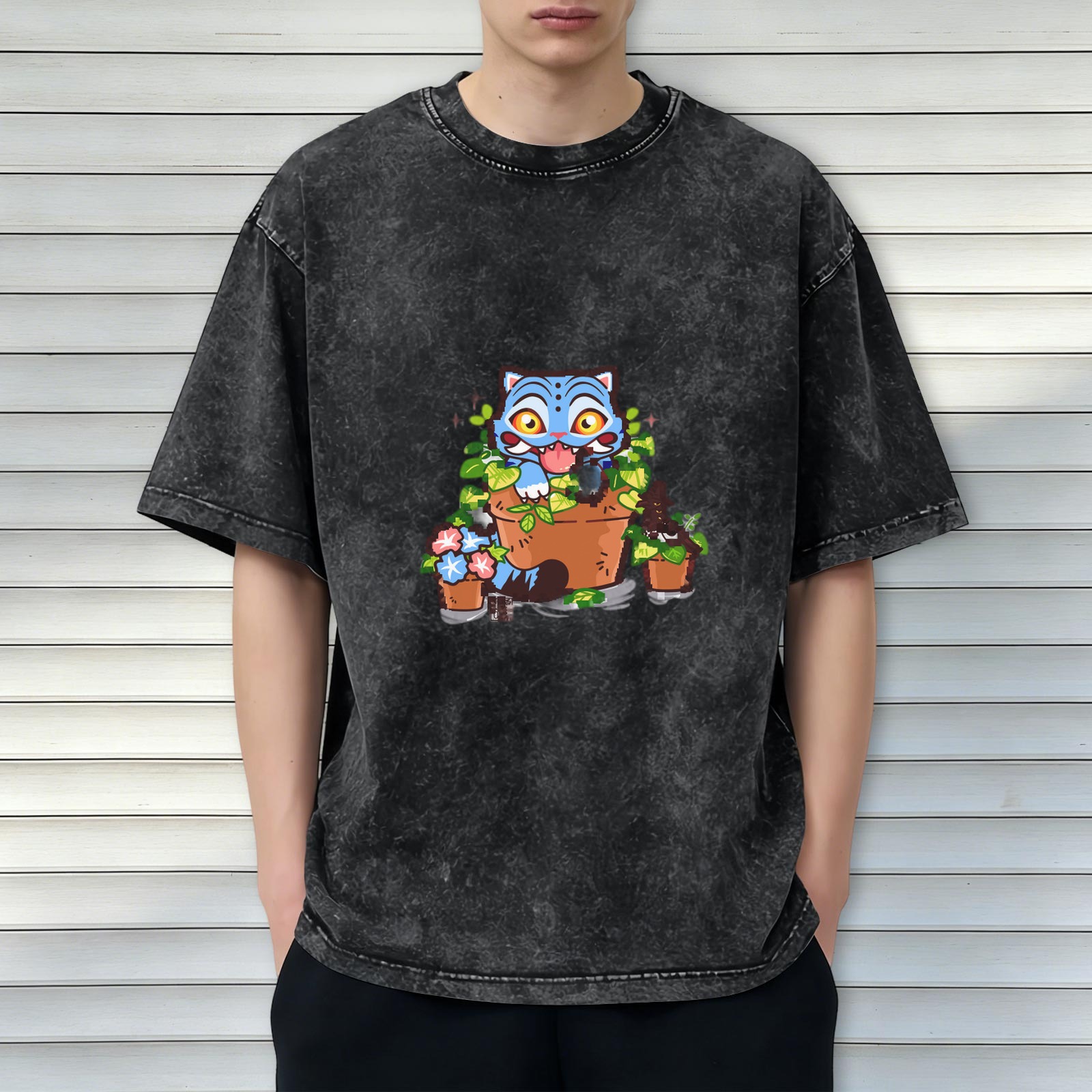 Washed black oversized t-shirt with playful blue cat in plant pots graphic