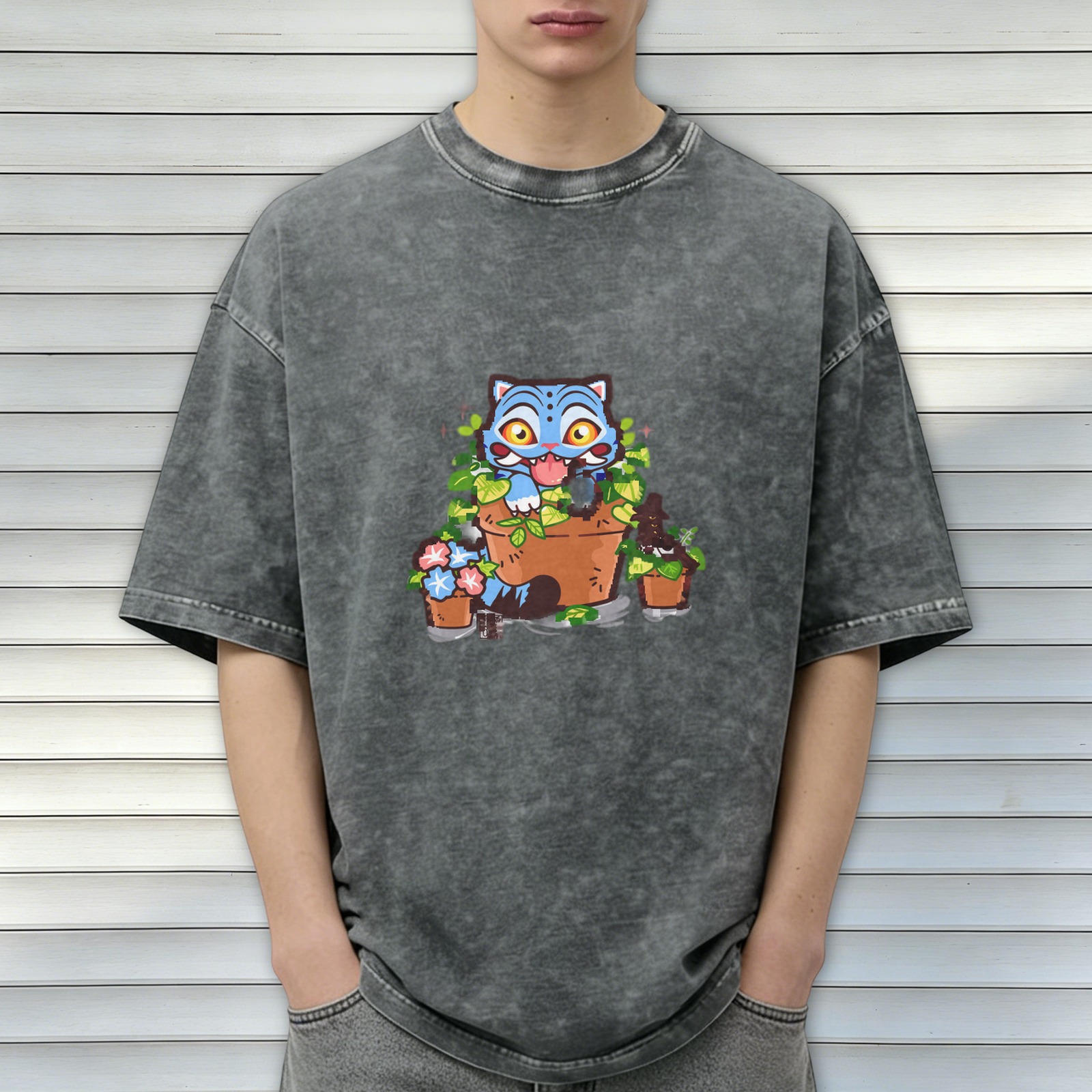 Washed black oversized t-shirt with playful blue cat in plant pots graphic