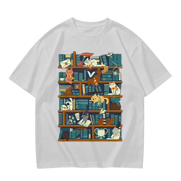 Olive t-shirt with playful cats on a bookshelf graphic