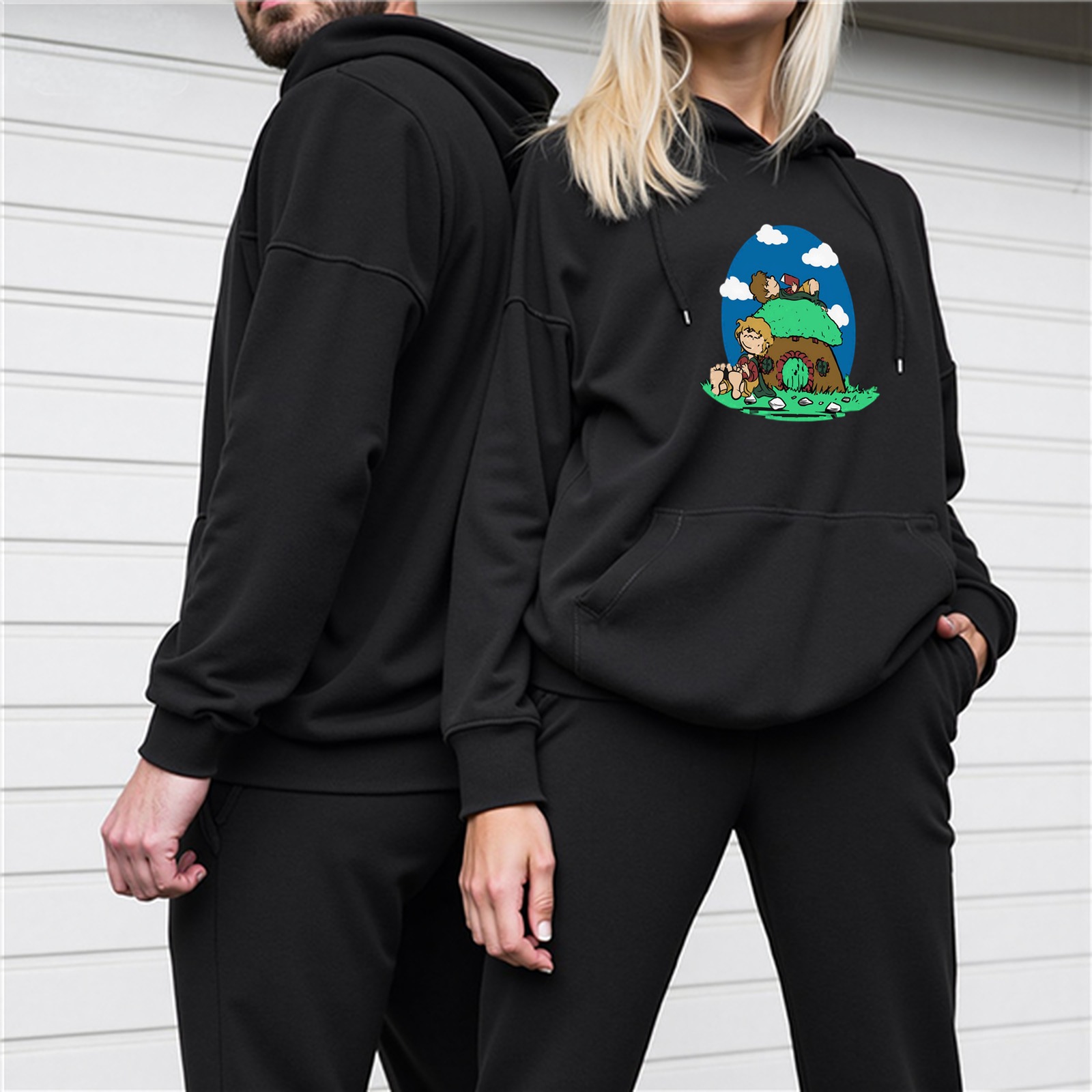 Black hoodie with mushroom house and cartoon characters graphic
