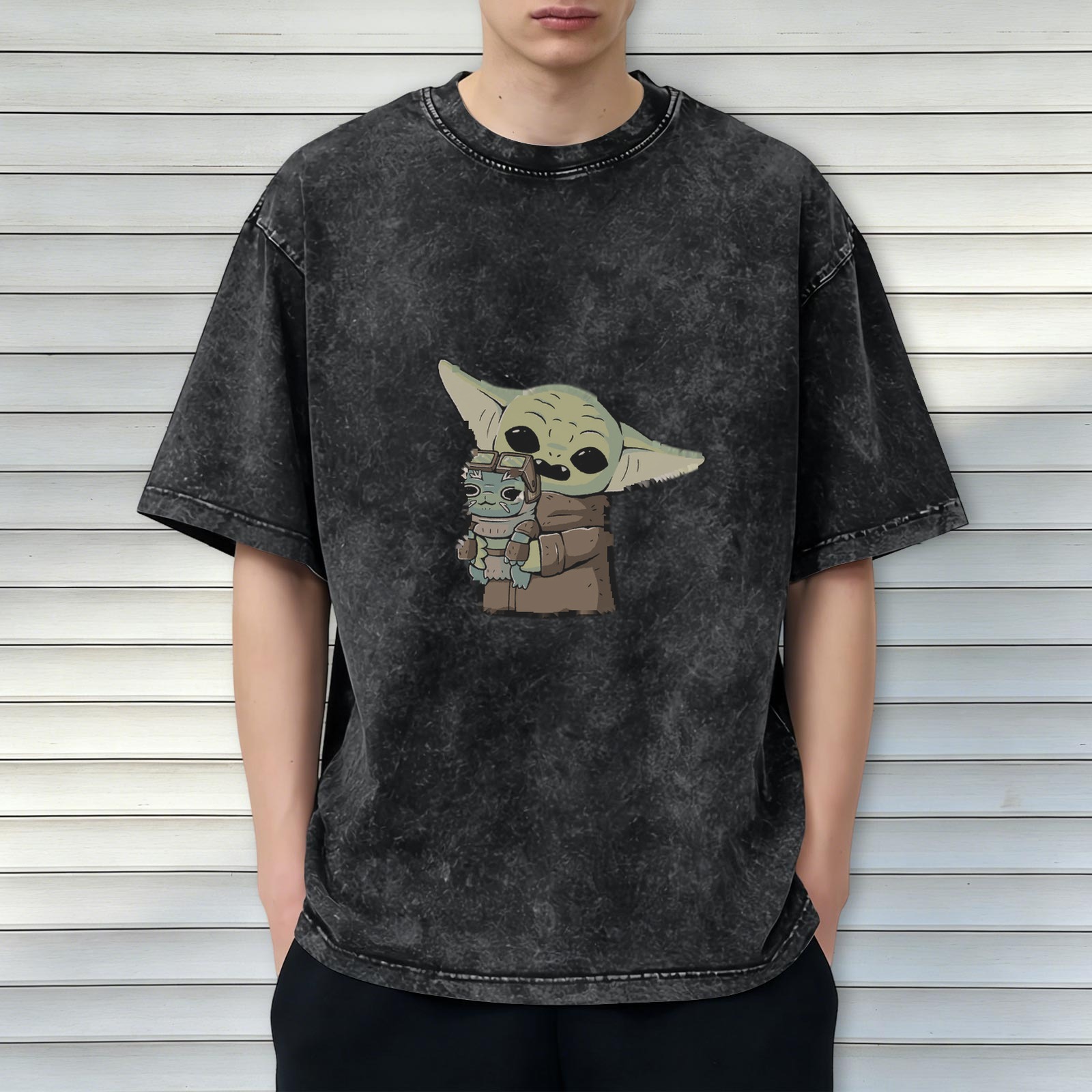 Washed black graphic t-shirt featuring Baby Yoda holding a small alien character