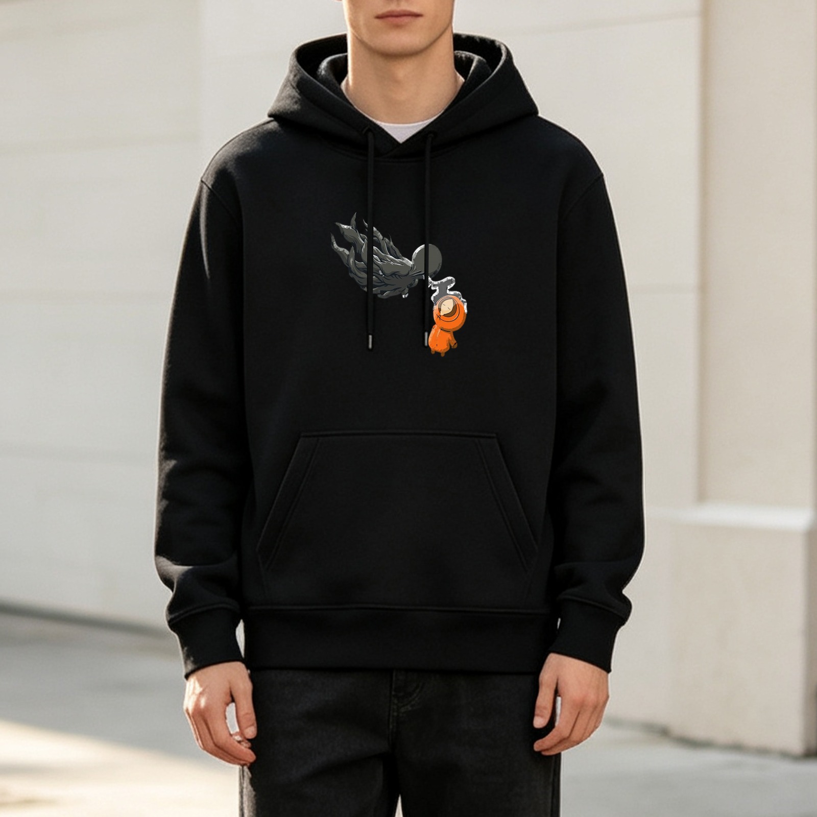 Black hoodie with dark shadow figure holding small orange character graphic