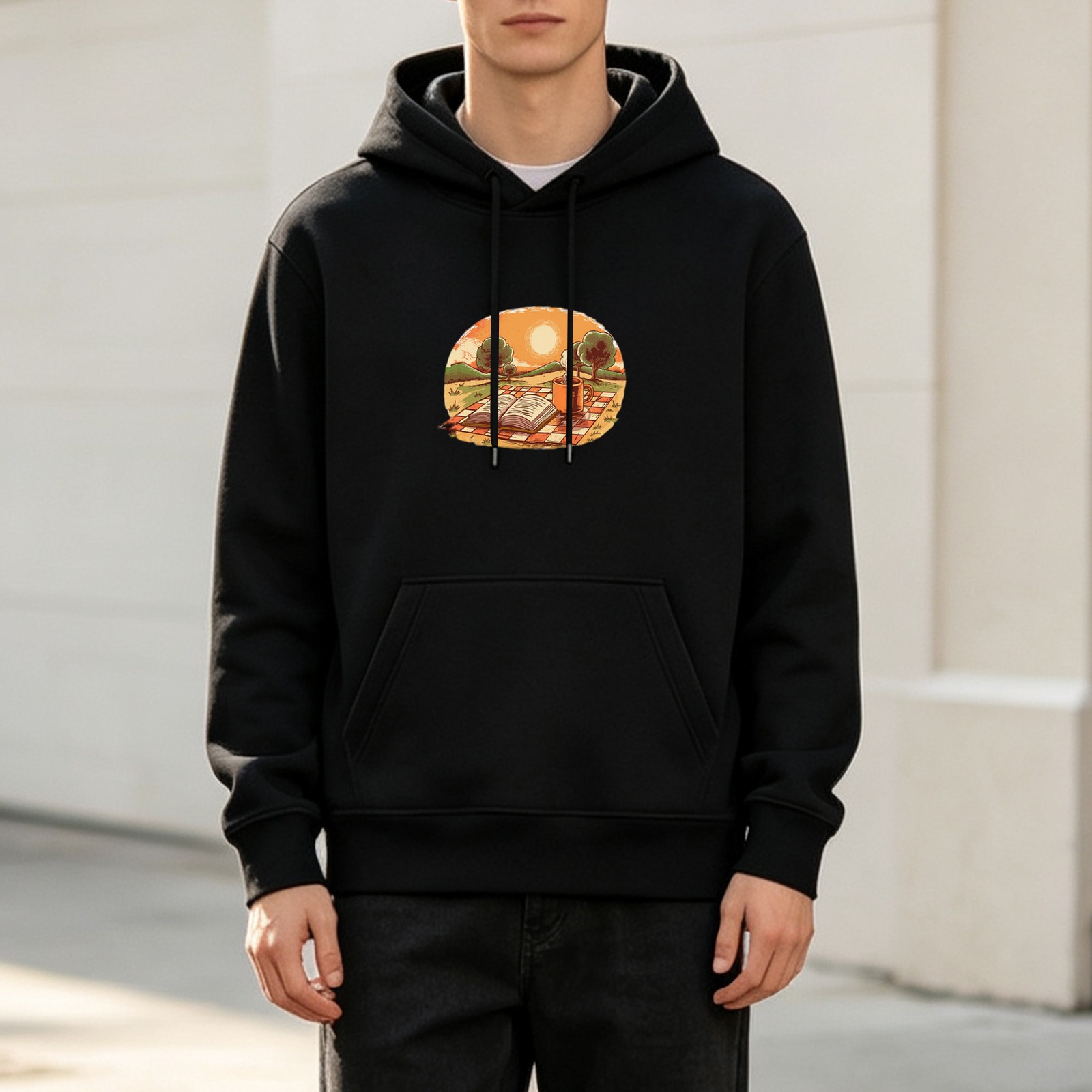 Black hoodie with sunset picnic and open book graphic