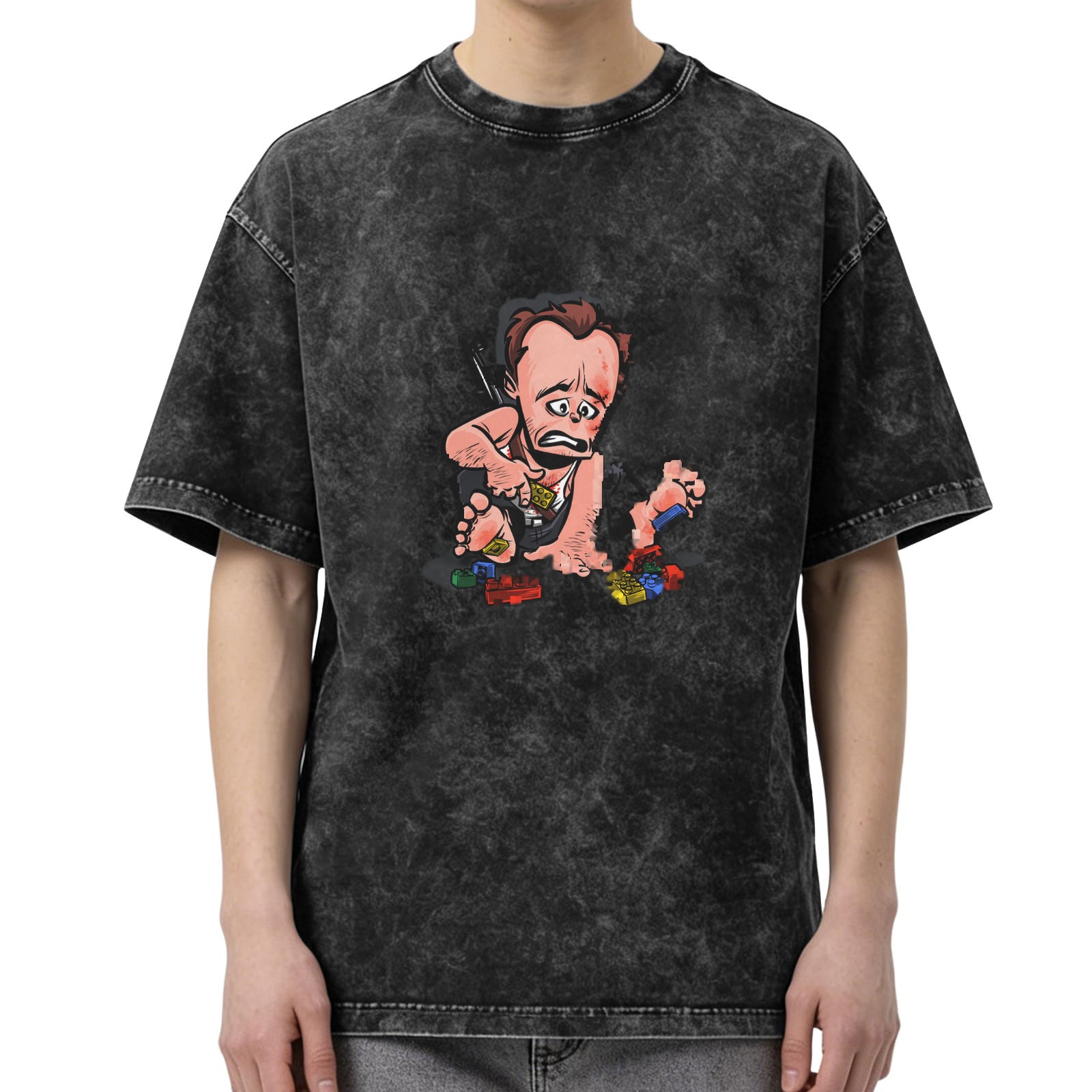Washed black graphic t-shirt with cartoon man stepping on lego design