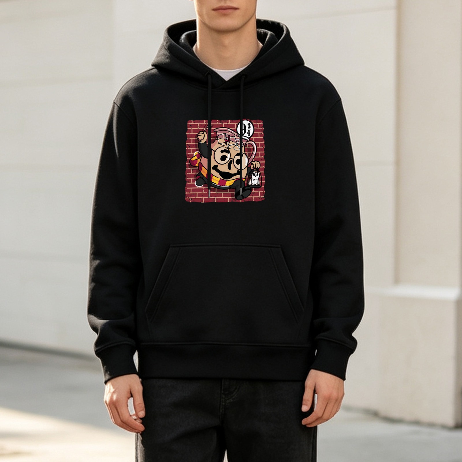 Black hoodie with Harry Potter themed cartoon print of a teapot at platform 9 3/4