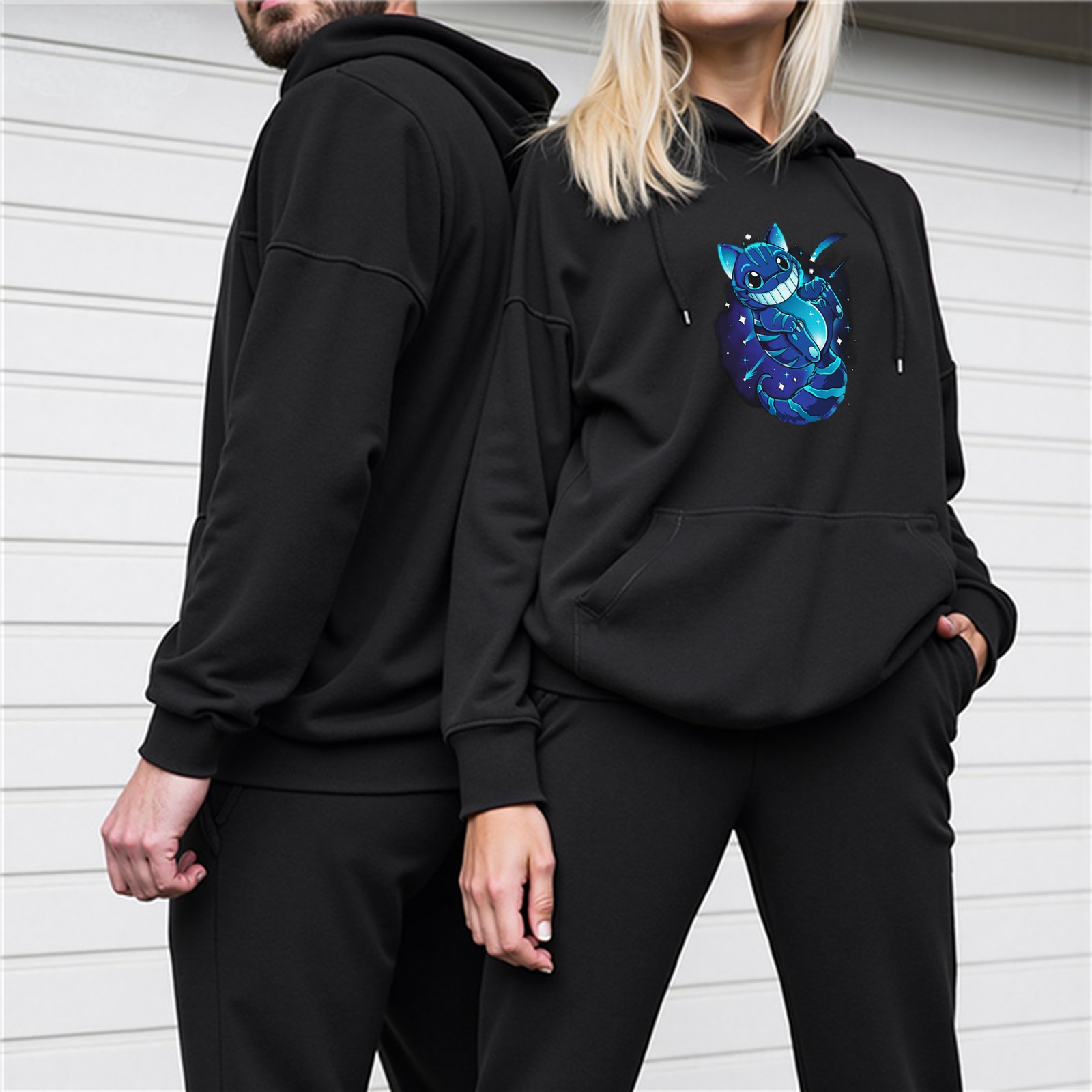 Black hoodie with glowing blue cheshire cat graphic
