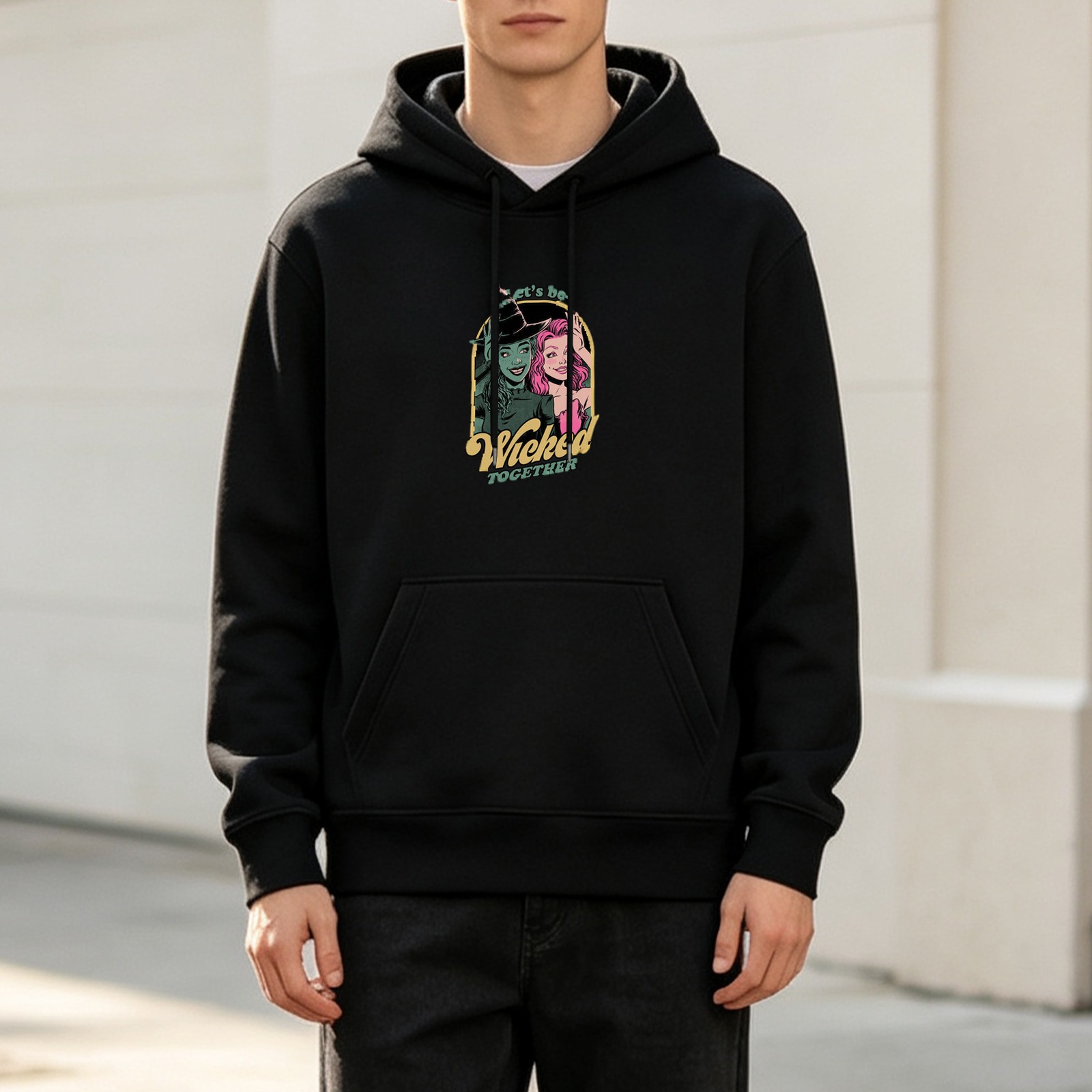 Black hoodie with Wicked Together graphic of two witches