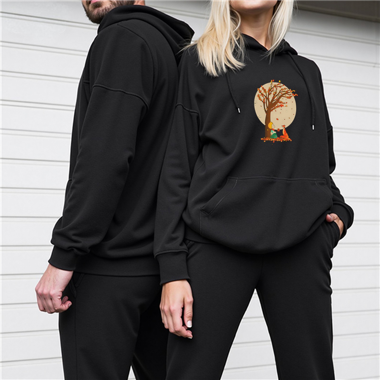 Black hoodie with autumn tree and small figure graphic