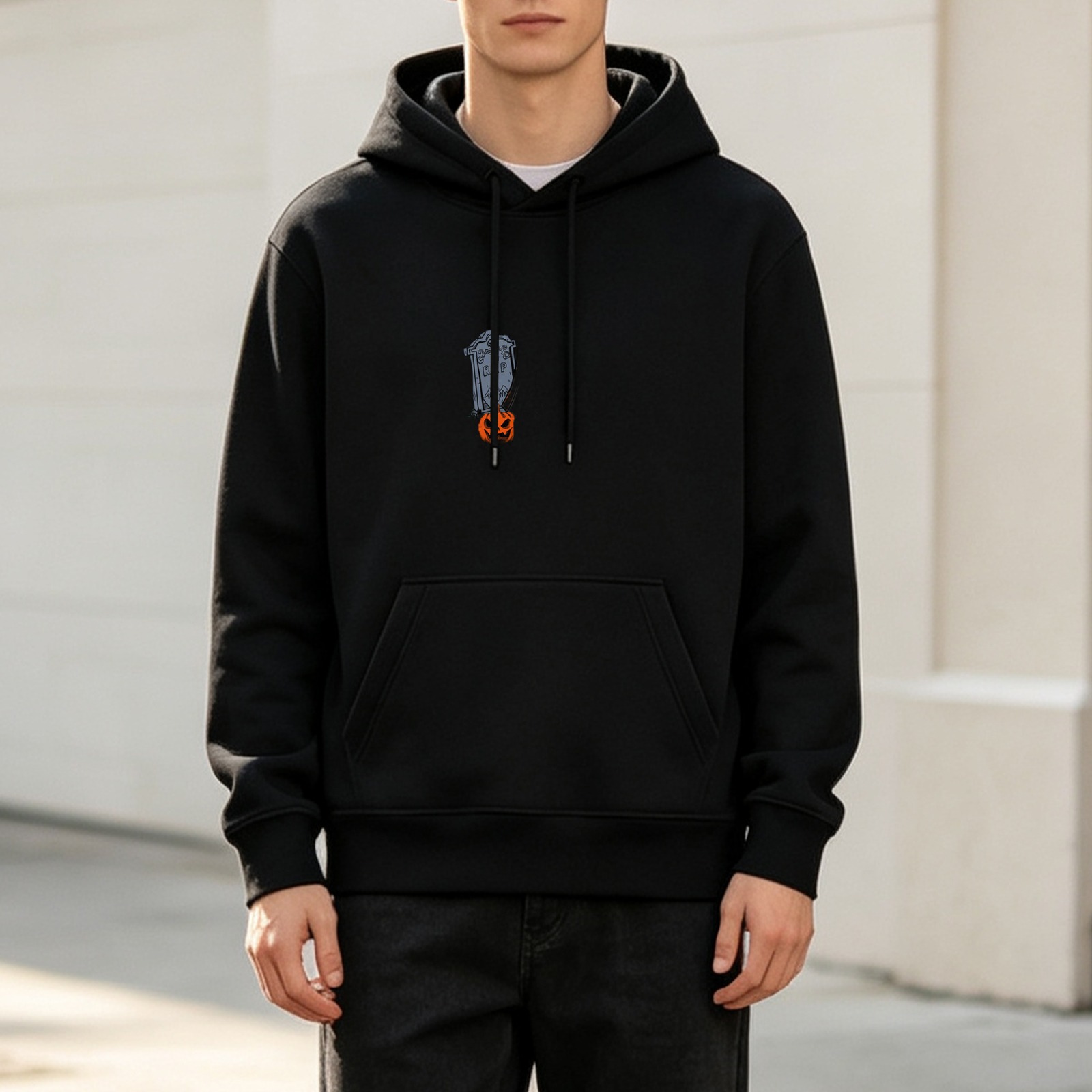 Black hoodie with small gravestone and jack-o'-lantern graphic