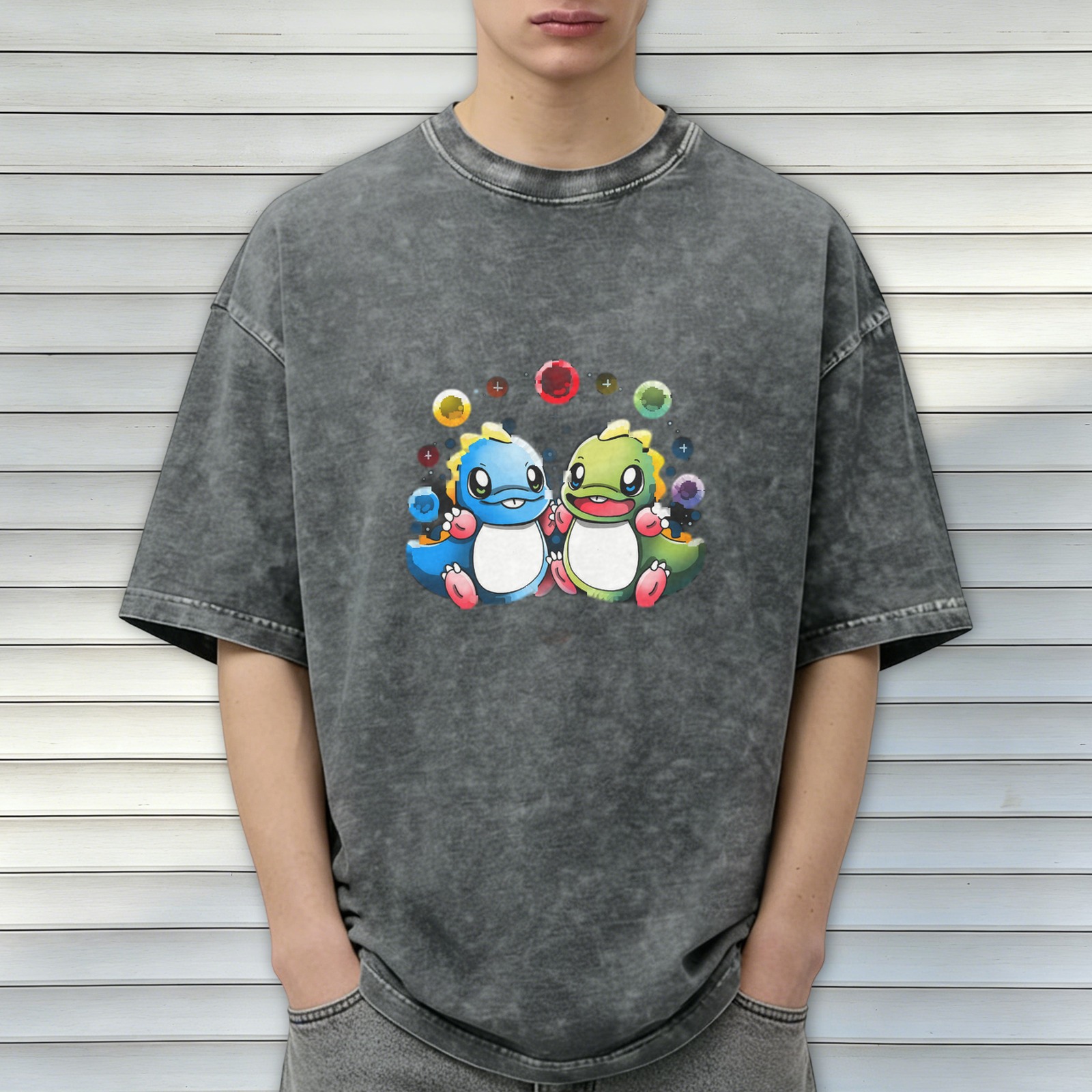 Washed black graphic t-shirt with cute cartoon dinosaurs and colorful bubbles