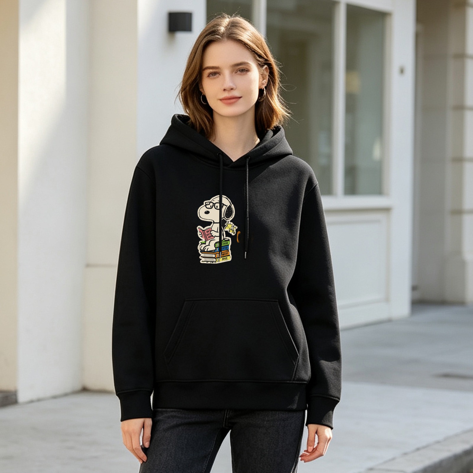 Black hoodie with Snoopy reading on stacked books