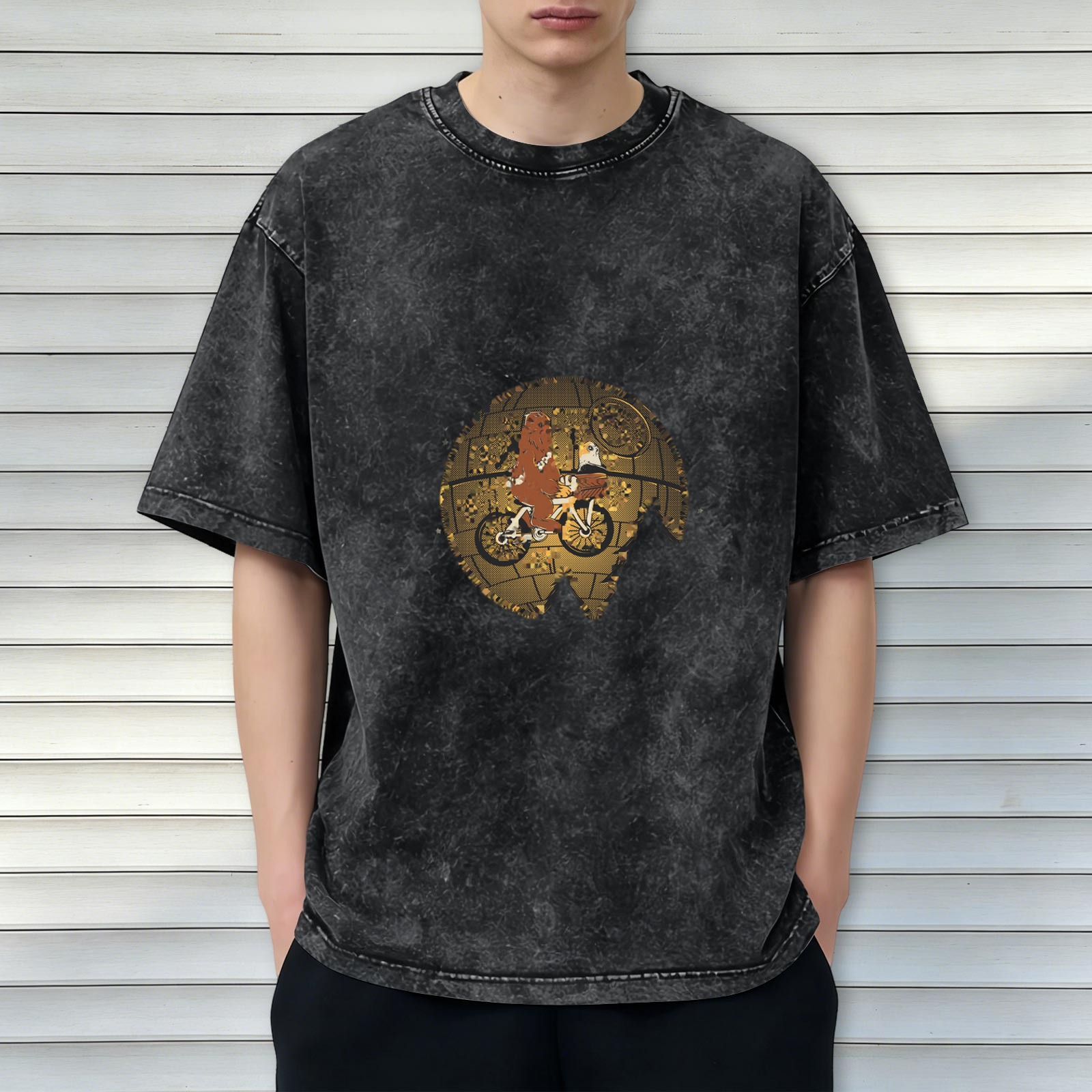 Washed black graphic t-shirt with alien on bike over gold globe design